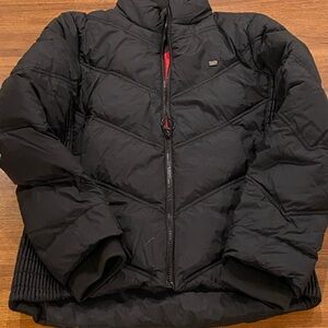 Lacoste Black Puffer Jacket with hot pink lining.